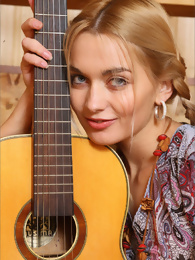 Sweet Lilya Posing with a Guitar