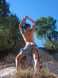 Layla Climbing a Rock Topless